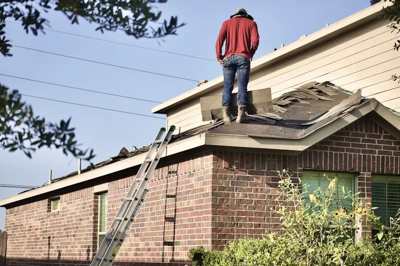 Professional roofer working on a residential roof in Emory Grove